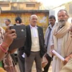 An Indian woman using a mobile phone to record an interview, showcasing the rise of digital and citizen journalism.