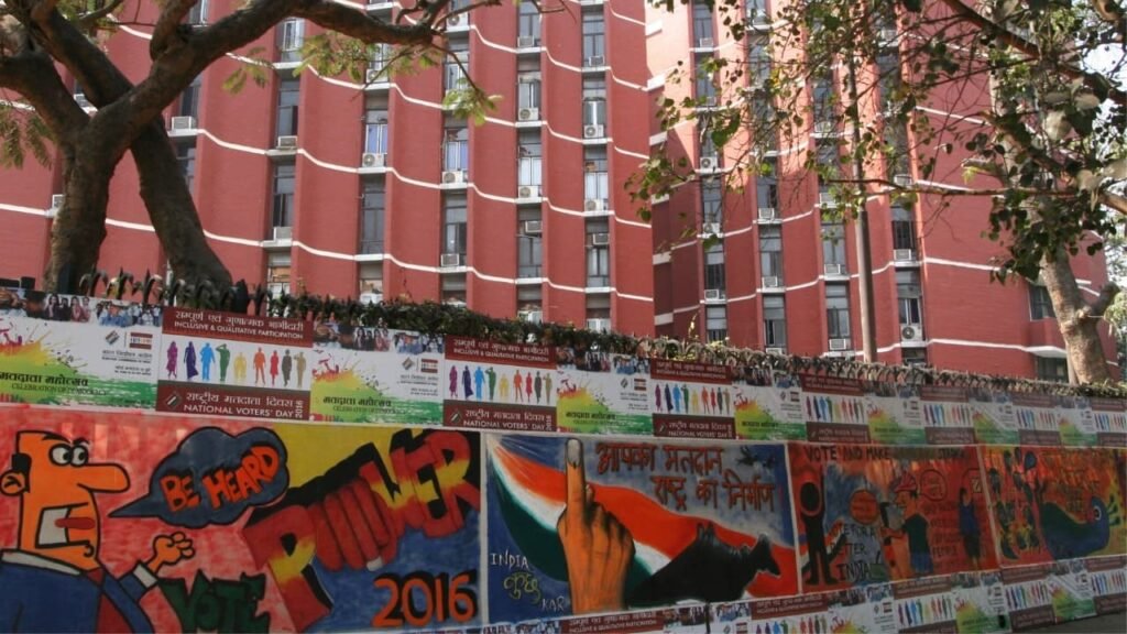 Election Commission of India building with banners promoting National Voters' Day, emphasizing electoral literacy.
