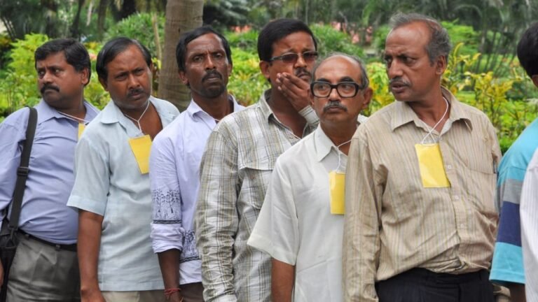 Group of men standing in line, highlighting social issues with mental health and the need for awareness.