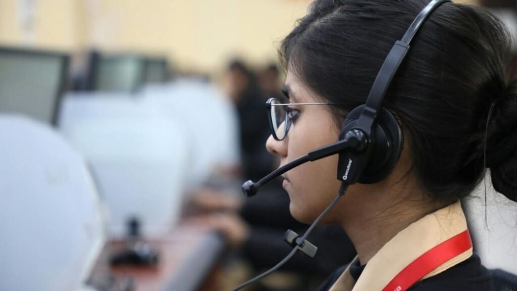 Woman with a headset working at a mental health helpline, highlighting awareness during Men's Mental Health Month.