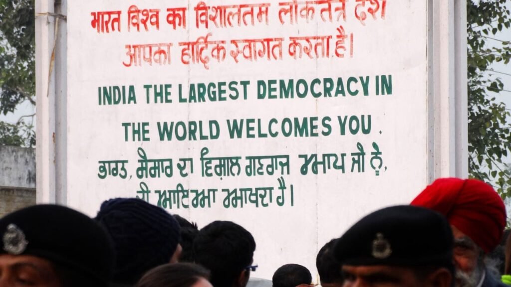 Sign reading 'India, the largest democracy in the world, welcomes you,' symbolizing India's democratic values and inclusivity.
