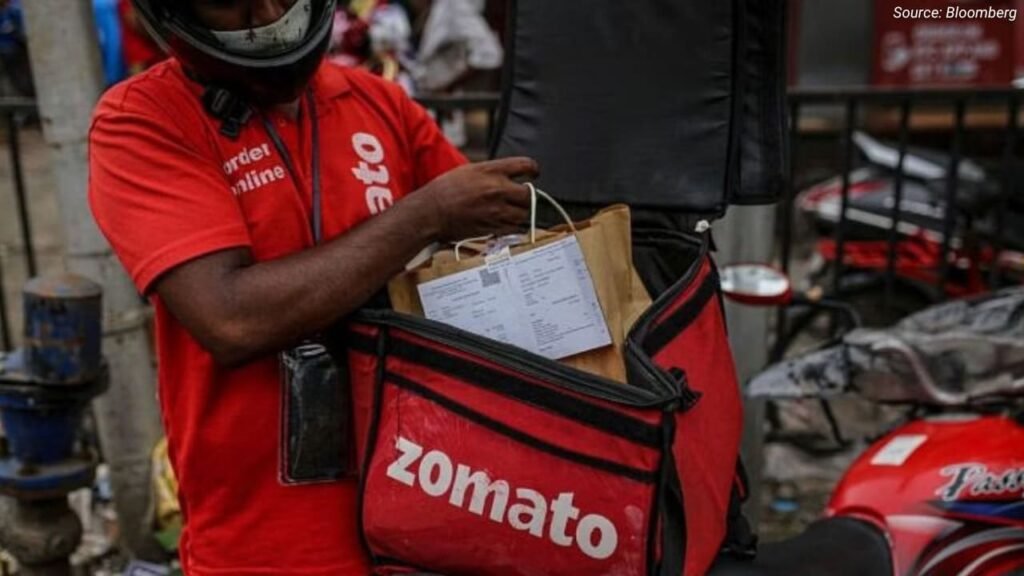 Zomato delivery person packing food into a delivery bag, illustrating gig economy jobs in India.
