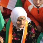 An women with indian flag highlighting the Identity politics in India.